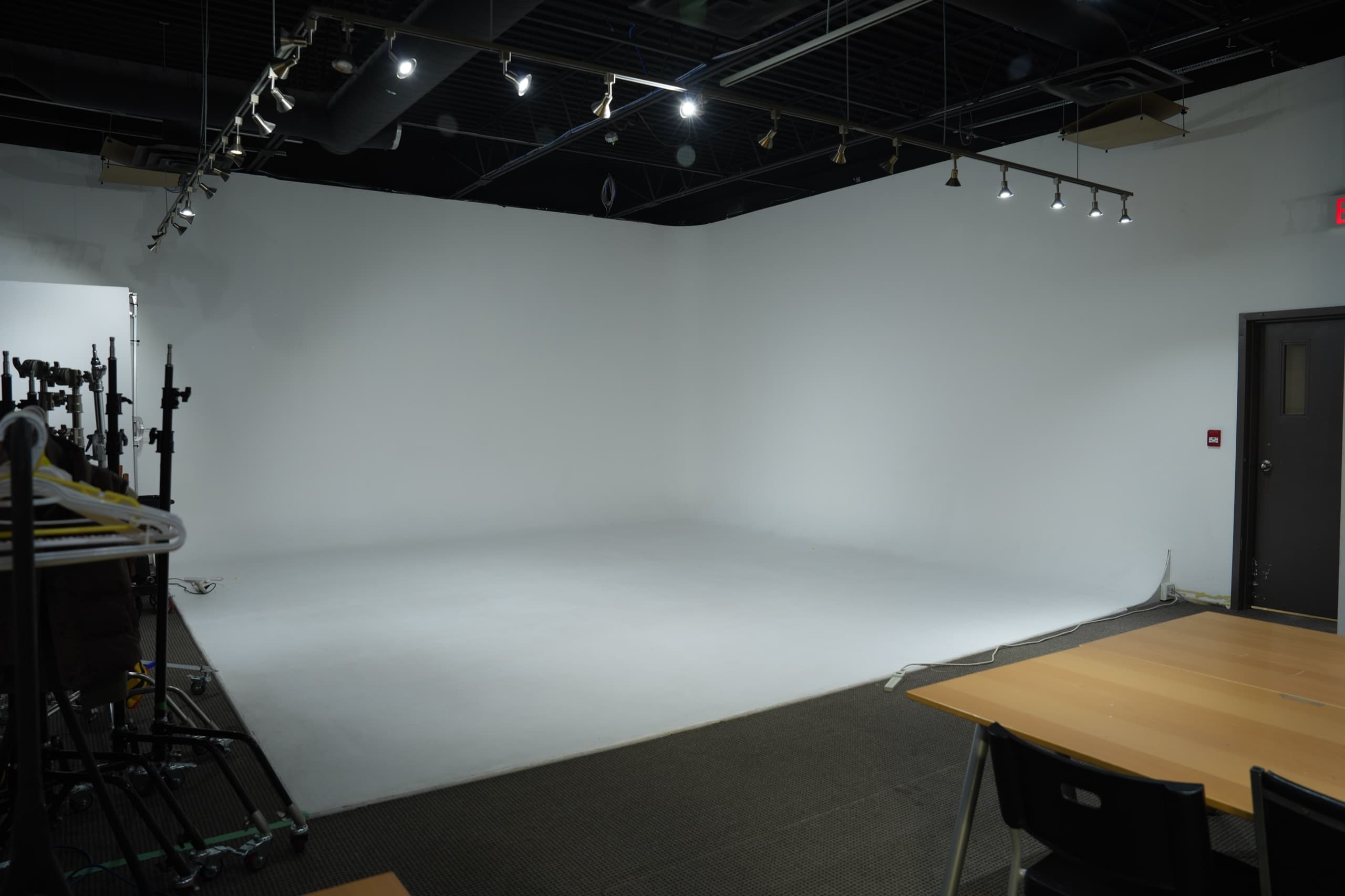 The two-wall cyclorama cove at Blank Studio, lit white, seen from the studio floor